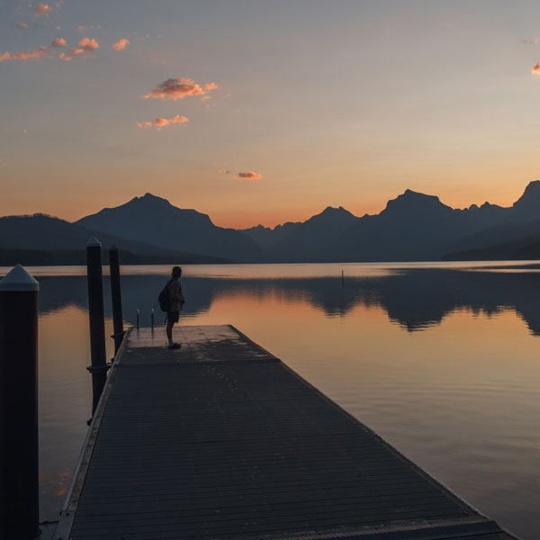 Person on lake boardwalk. 