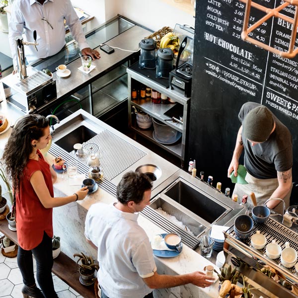 Customers drinking coffee at cafe.